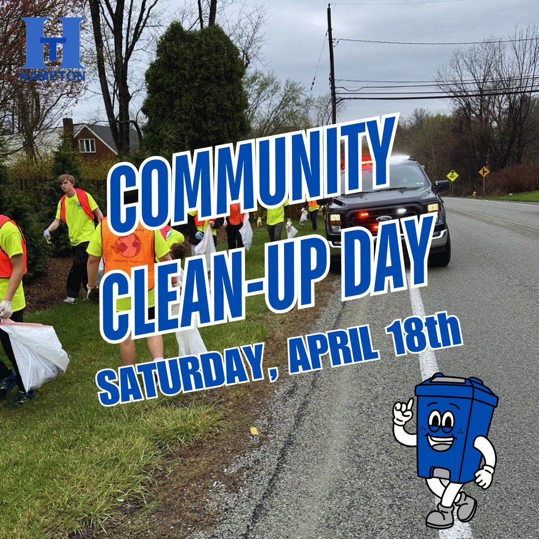 Community members help to pick up trash and debris from a nearby road.